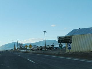 A mileage sign is posted at the California 139 north and California 161 west intersection. Dorris is 23 miles west of here, and Klamath Falls, Oregon, is 24 miles north of here. Turn right to follow county-maintained State Line Road east to Malin, Oregon (seven miles). After this intersection, California 139 will end and Oregon 39 will begin.