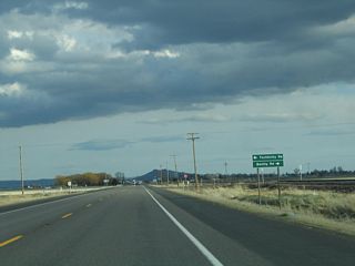 Southbound California 139 approaches Tschirky Road east and Kandra Road west. Both county roads provide local farm and ranch access. The railroad parallels California 139 south through Tulelake to Canby, then turns east to Alturas and the U.S. 395 corridor.