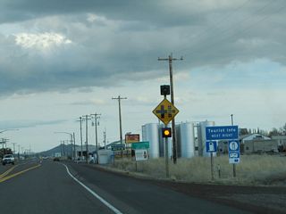 SR 139 runs along the east side of the city of Tulelake (population 1,020 as of the 2000 Census). Main Street ties into SR 139 north from Downtown across from Havlina Road. Main Street south also links SR 139 with Volcania Legacy Scenic Byway west to Lava Beds National Monument. Ancient lava flows, lava tubes (caves formed by historic lava flows), and craters are among the many features to the unique landscape at the monument.