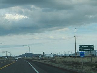 Southbound California 139 approaches East-West Road west to Sheepy Peak along the north shore of Tule Lake and Osborne Road east into Modoc County.
