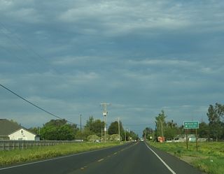 About a mile east of Applegate Road, eastbound California 140 (McSwain Road) approaches Buhach Road.