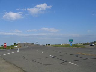 California 140 east at the interchange (Exit 418) with Interstate 5 west of Gustine. From here, California 140 follows a two-lane bridge over Interstate 5, passes by a few gas stations, then proceeds toward Gustine. Almost immediately, California 140 leaves Stanislaus County and enters Merced County.