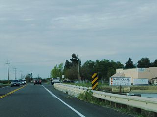 Northbound California 33 and eastbound California 140 cross over the Main Canal on this bridge. Note that California 140 is the through route, since the bridge number corresponds to State Route 140.