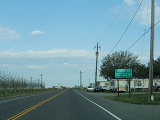 The next major intersection along eastbound California 140 is with Hunt Road north and East Avenue south.