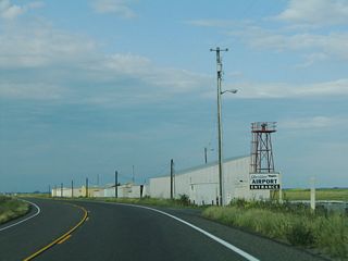 California 140 passes by the Gustine Airport as it leaves the urban area and prepares to enter the San Luis National Wildlife Refuge.