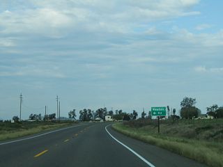 California 140 leaves the national wildlife refuge after crossing the San Joaquin River. The next major intersection is with Keaton Road north to Merced County J-18 (Westside Boulevard).