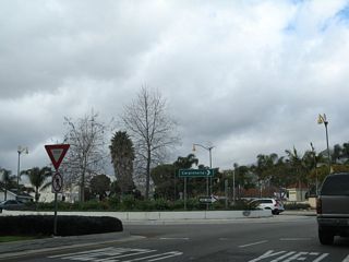 After passing under U.S. 101, Milpas Street enters a roundabout that connects the road with a U.S. 101 off-ramp and Carpinteria Street.