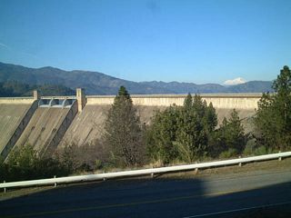 With its white peak appearing along the horizon, Mount Shasta, one of two volcanoes in northern California, rises in the distance.