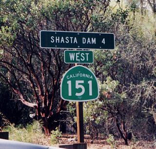 California 151 is a short route that connects Interstate 5 with Shasta Lake (artificial lake created by the damming of the Sacramento River) north of Redding. This picture shows westbound California 151 after Lake Boulevard, four miles east of the dam. Most of California 151 from this spot rises in elevation as it approaches the dam itself.