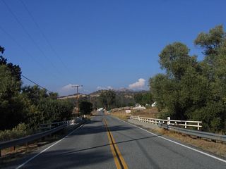 Built in 1943, this bridge carries California 155 (Garces Highway) over Poso Creek west of Glennville. Due to the war effort at the time, old railroad surplus items were reused for this bridge, including the railing.