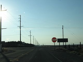 California 155 meets California 65 at this stop sign. Through traffic on California 65 does not stop at this intersection.