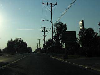SR 155 makes an unmarked turn along Fremont Street north to connect with the SR 99 entrance ramp for the Golden State Freeway north to Fresno, Modesto, and Sacramento.