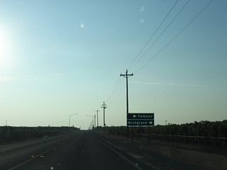 Westbound California 155 meets Famoso-Porterville Highway at this stop sign. Famoso-Porterville Highway parallels an abandoned Southern Pacific Railroad line north to Richgrove.