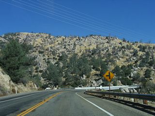Curving eastward over an arm of Isabella Lake, SR 155 (Kernville Road) spans the French Gulch Bridge at French Gulch.