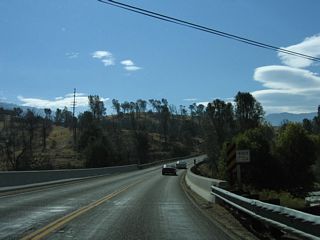 Eastbound California 155 (Kernville Road) crosses over the Kern River, which spills out of the Isabella Dam complex.
