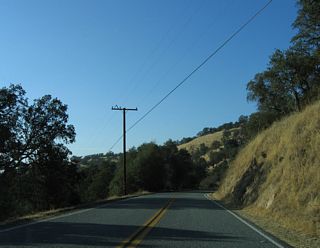 California 155 continues west through the foothills toward Delano.