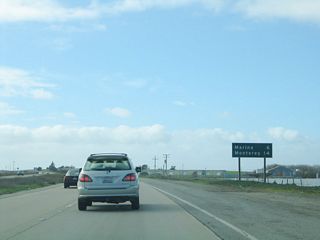 This mileage sign provides the distance to Marina (six miles) and Monterey (14 miles).