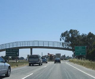 Nearing a pedestrian bridge, the left two lanes of westbound California 156 will connect directly onto California 1 (Cabrillo Highway) south to the Monterey Peninsula. The right lane connects to Exit 1B, California 183.