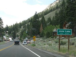 California 158 enters the unincorporated community of June Lake (population 613 as of 2000 Census). With tourism as a major factor in the local economy, many of the businesses are geared toward tourist activities in the area, both Winter and Summer.