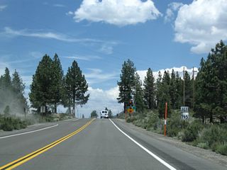 The power line bringing electricity from the Rush Creek Hydroelectric Project into the power grid passes over California 158 prior to the intersection with U.S. 395 at June Lake Junction.
