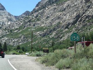 A California 158 south reassurance shield precedes the turnoff for the Rush Creek trailhead.