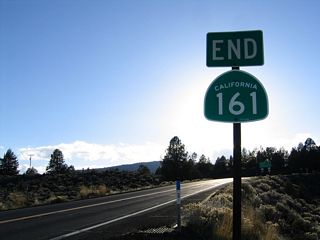 SR 161 ties into U.S. 97 northwest of Indian Tom Lake and east of Dorris Hill.