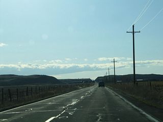 Passing through Ainsworth Corner, westbound California 161 will pass through the High Rim (note road cut in the distance), then descend toward the Lower Klamath Lake.