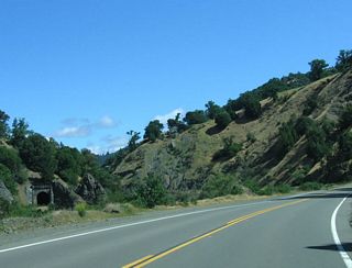 A train tunnel can be seen along California 162 as the highway continues to follow the Eel River.