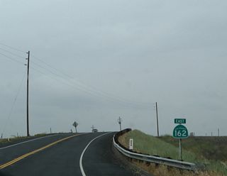Now in the Sacramento Valley and traveling east along California 162 after the northern California 99 intersection, this California 162 route marker points the way east toward Oroville.