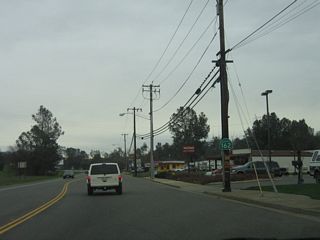 A California 162 route marker is posted soon after the Washington Avenue intersection. California 162 will leave the urbanized area of Oroville and continue toward Lake Oroville State Recreation Area.