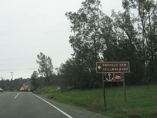Eastbound California 162 (Oroville-Quincy Highway) approaches the turnoff to CR B-2 (Canyon Drive) north to Oroville Dam. The county route designation is poorly signed; it takes Canyon Drive north to Oroville Dam Boulevard, then turns west on Oroville Dam Boulevard, Orange Avenue, and Montgomery Street into downtown Oroville.