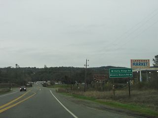 Continuing east, California 162 (Oroville-Quincy Highway) approaches the intersection with Kelly Ridge Road (north) and Miners Ranch Road (south). Use Kelly Ridge Road north to the Lake Oroville State Recreation Area Visitors Center.