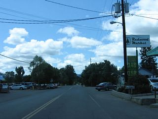 California 162 travels south through the town of Covelo, passing by downtown shops and gas station.