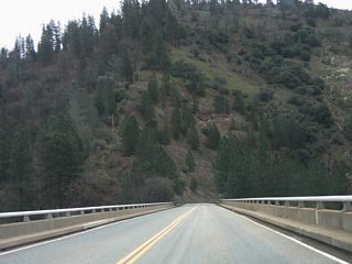 Westbound California 162 crosses over the Canyon Creek Bridge, which has two lanes and no shoulders.