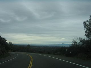 The Sacramento Valley and Sutter Buttes come into view as California 162 loses elevation within the state recreation area.