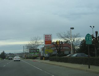 A California 70 Business reassurance marker is posted after the Lincoln Street intersection.