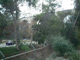 Viewing the Cabrillo Bridge to the southeast from a path in Balboa Park. The bridge was constructed between 1912 and 1914, withSan Diego Union-Tribuneindicating that then-Assistant Secretary of the Navy Franklin Roosevelt was the first to drive across the new bridge. He later became President of the United States. The bridge was in full use in 1915 as part of the Panama-California Exposition.