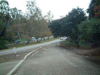An entrance ramp previously connected Quince Street east with SR 163 south. Remnants of the abandoned ramp remain.