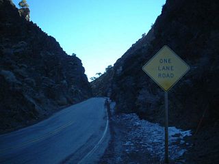 California 168 crosses Westgard Pass via this narrow one-lane segment. Although it does not seem like it, this picture was taken mid-morning, not at twilight. The area looks dark because the sunlight did not reach this narrow chasm on this Winter morning.