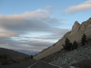 A large rock slide dominates the view as SR 168 continues toward the small community of Aspendell.