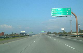 Angling toward the northeast, California 168 (Sierra Freeway) approaches Exit 4, Shaw Avenue, one-half mile.