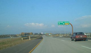 Eastbound California 168 (Sierra Freeway) reaches Exit 7, Herndon Avenue. The freeway narrows from six to four lanes at Exit 7.