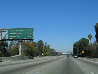 This mileage sign along northbound California 170 (Hollywood Freeway) provides the distance to the next three exits: Exit 6, Magnolia Boulevard/North Hollywood; Exit 7, Burbank Boulevard; and Exit 8A, Oxnard Street. Note how tight the high occupancy vehicle lane is against the median barrier!