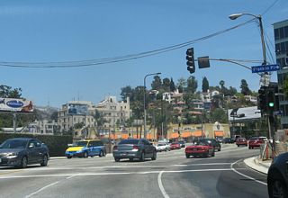 The world-famous HOLLYWOOD sign comes into view on the hillside behind a church near the Franklin Place intersection.