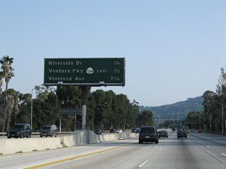This mileage sign provides the distance to the final two exits from California 170 (Hollywood Freeway) south: Exit 6A, Riverside Drive and Exit 5B, California 134 (Ventura Freeway) east to Glendale and Pasadena (Hollywood Split Interchange). The other exit listed here is for Exit 12B, Vineland Avenue, which is the next exit from U.S. 101 (Hollywood Freeway) south after California 170 merges with U.S. 101. Notably, this sign is one of the few remaining examples of a white button copy state route shield.