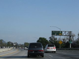 Southbound California 170 (Hollywood Freeway) reaches Exit 8A, Oxnard Street (east-west) and Laurel Canyon Boulevard (north-south).