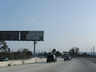 A high occupancy vehicle lane (HOV+2) begins on the left side of the Hollywood Freeway.