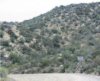 Eastbound California 173 as the dirt road begins. The sign says that the road is closed, but no barricades prevent travelers from driving California's only remaining dirt state route.