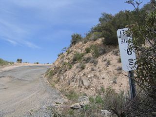 The dirt road section of California 173 is fully mileposted. This is the first milepost after California 173 changes into a dirt road east of Arrowhead Lake Road.