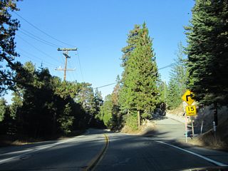 Several sharp turns -- along with driveways, downhill slopes, slow traffic, and changing weather conditions -- warrant a slower speed on mountainous California 173 northward into Lake Arrowhead Village.